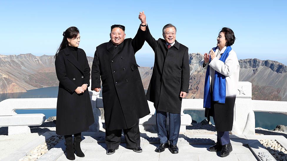 North Korean leader Kim Jong Un (2nd L) and his wife Ri Sol Ju (L) pose with South Korean President Moon Jae-in (2nd R) and his wife Kim Jung-sook (R) on the top of Mount Paektu on September 20, 2018 in Mount Paektu, North Korea. (Photo by Pyeongyang Press Corps/Pool/Getty Images)