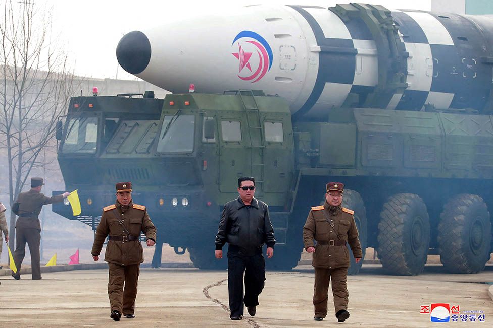 Kim Jong-un pictured in front of North Korea's largest known intercontinental ballistic missile