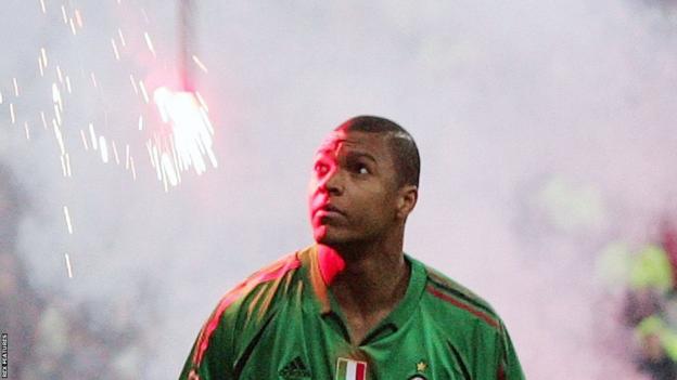 AC Milan goalkeeper Dida watches as a flare tumbles towards him in the 2005 Champions League quarter-final against AC Milan