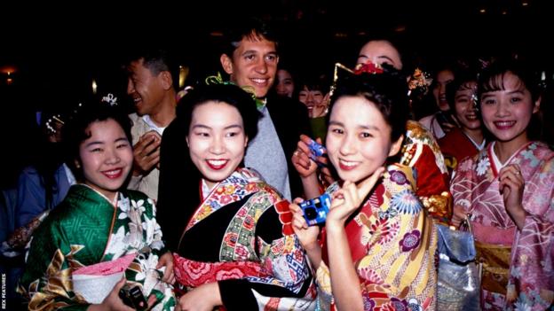 Gary Lineker surrounded by fans in traditional Japanese dress during his time in Nagoya