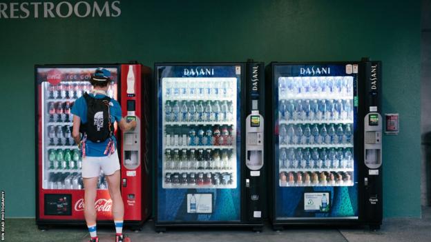 James Poole buys drinks from vending machines on the 2022 The Speed Project