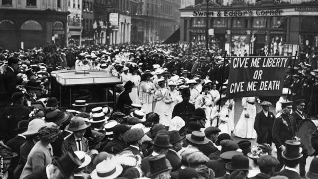 The funeral process for Emily Davison featuring a banner proclaiming 'Give me liberty or give me death'