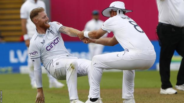 Ben Stokes is helped to his feet by England team-mate Stuart Broad