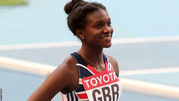 Dina Asher-Smith smiles before the start of a relay heat