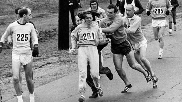 Kathrine Switzer resists an attempt to seize her race number