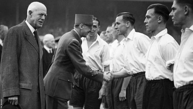 General Koenig, the French Governor of Paris, shaking hands with England defender Neil Franklin in 1945, with Frank Soo beside Franklin