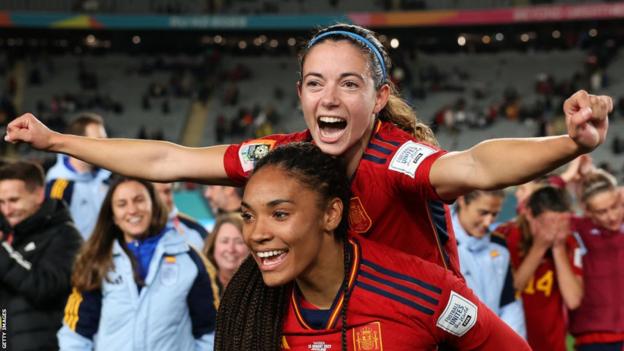 Aitana Bonmati is lifted up in celebration by a Spain team-mate after their World Cup win in Australia in 2023