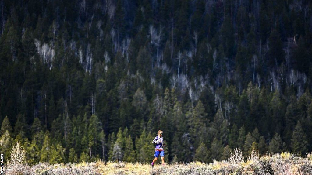 Courtney Dauwalter trains in front of a backdrop of Colorado forest