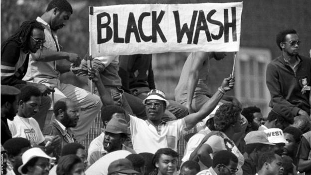 A spectator holds up a sign reading 'Black Wash' after the West Indies series whitewash of England in 1984