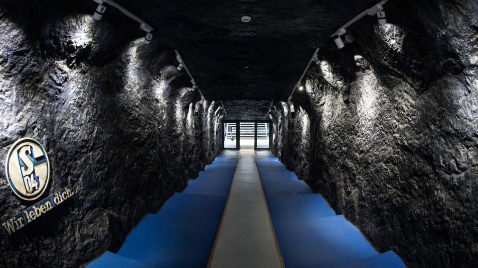 The tunnel of the Veltins Arena with walls to look like a mine shaft