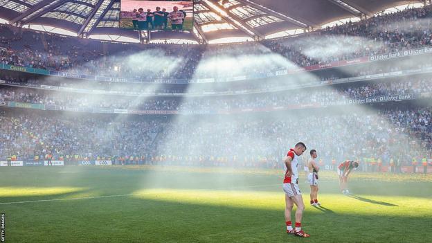 Mayo's players look dejected while light streams down on them from above Croke Park's stands