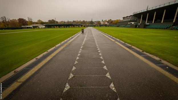 The empty walkway between outside courts on a cloudy day at Wimbledon