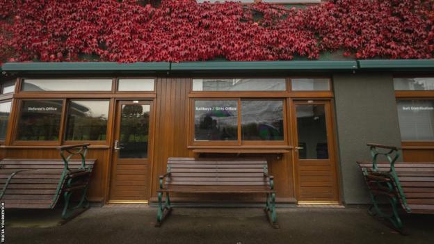 Benches stacked in front of the referee's office at Wimbledon