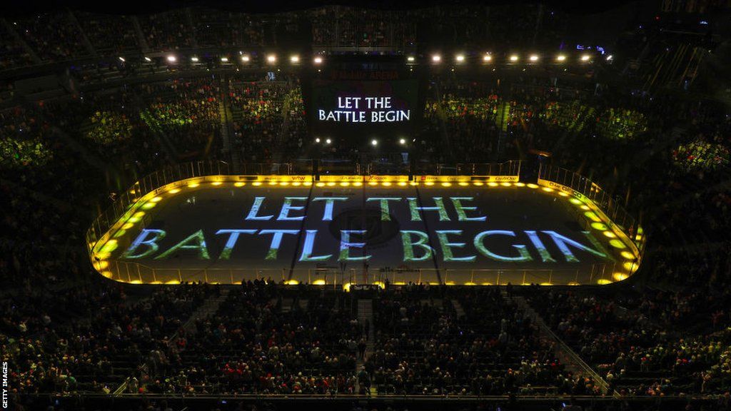 The words Let Battle Begin are projected onto the ice at a Golden Knights home game